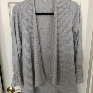 Gray sweater with bell sleeve detail.